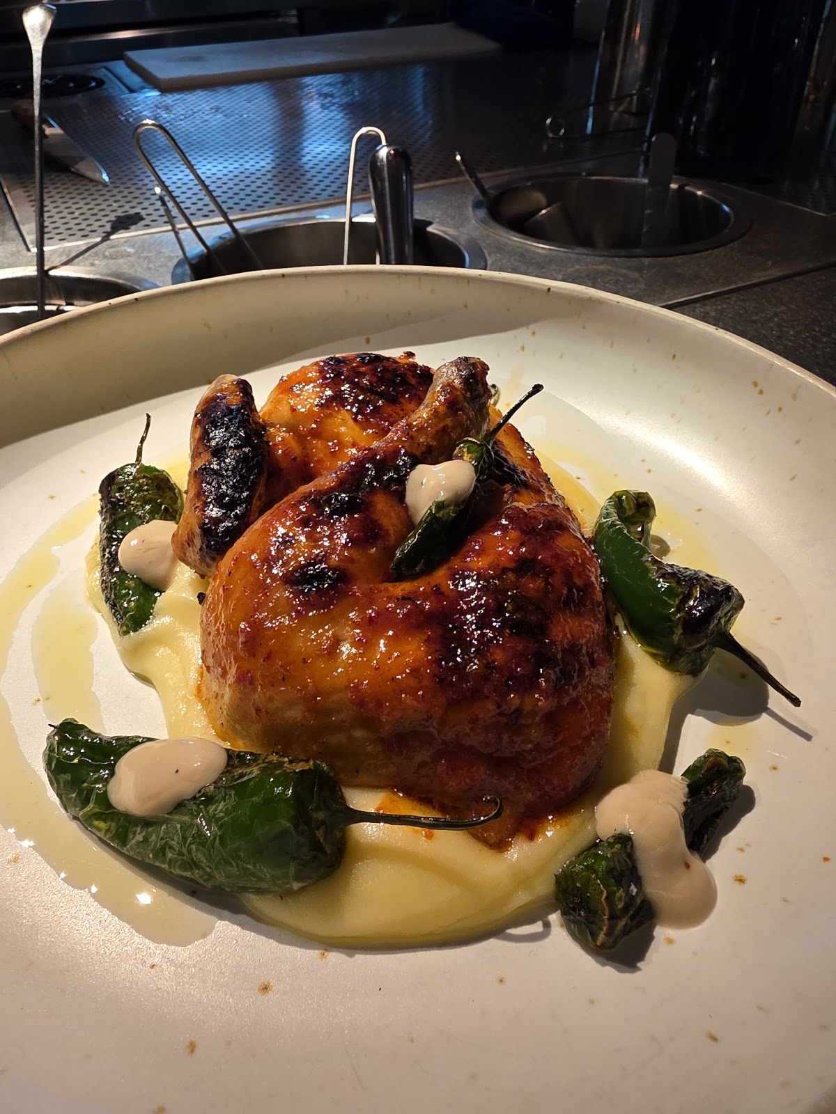 Roasted spring chicken with charred peppers and cream sauce